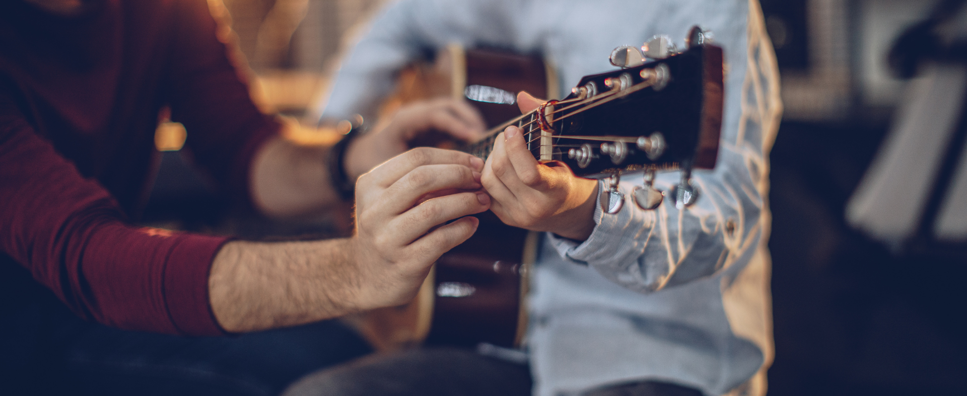 Nen tocant guitarra acústica amb professor